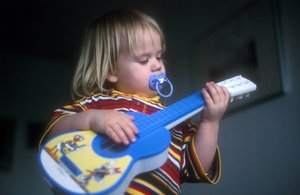 Akustisk gitarr i trä med strängar i varmt ljus